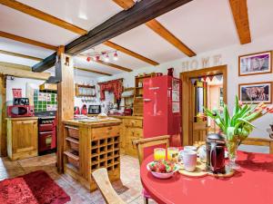 a kitchen with a red table and a red refrigerator at 4 Bed in Lydney oc-55969 in Bream