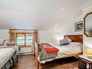 a bedroom with two beds and a window at 4 Bed in Lydney oc-55969 in Bream