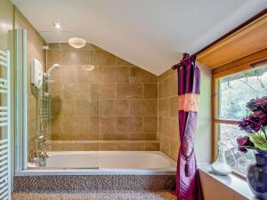 a bathroom with a tub and a window at 4 Bed in Lydney oc-55969 in Bream +20 photos