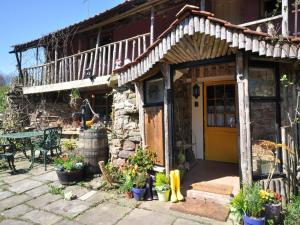a house with a yellow door and a patio at 4 Bed in Lydney oc-55969 in Bream