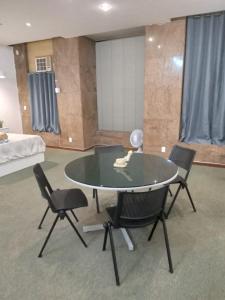 a room with a table and chairs and a bed at Apto Candelária in Rio de Janeiro