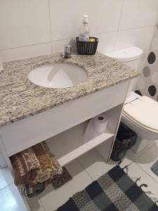 a bathroom with a sink and a toilet at Apto Candelária in Rio de Janeiro