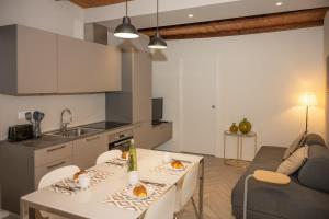 a kitchen and living room with a table and a couch at Ledy Apartment in Lovere