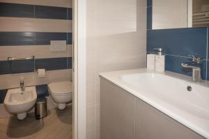 a bathroom with a sink and a toilet at Ledy Apartment in Lovere +36 photos