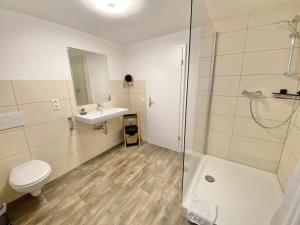 a bathroom with a shower and a toilet and a sink at Ferienwohnung Kleinôd Sayn in Bendorf +15 photos