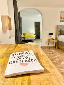 a book sitting on a table in a living room at Ferienwohnung Kleinôd Sayn in Bendorf