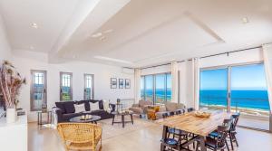 a living room with a view of the ocean at Borderline in Al Matlīn