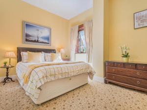 a bedroom with a bed and a dresser and a window at 1 Bed in Penrith oc-sz350 in Orton