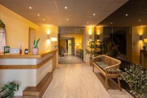 a lobby of a hospital with a waiting room at L'Aptois Hôtel - Centre Ville - Local Vélos in Apt