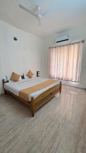 a large bed in a room with a window at Noble Grand Villa in Mahabalipuram +23 photos