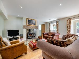 a living room with two couches and a tv at 3 Bed in Hexham oc-96038 in Bardon Mill