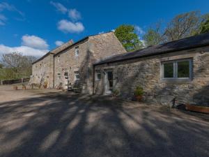 an old stone building with a large window at 3 Bed in Hexham oc-96038 in Bardon Mill