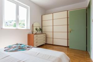 a bedroom with a bed and a dresser and a mirror at Villa Florence - Mediterranean GardenPool in Zaton +37 photos