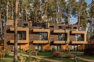 a building with balconies in front of trees at Glіbіvka Family Park in Glebovka