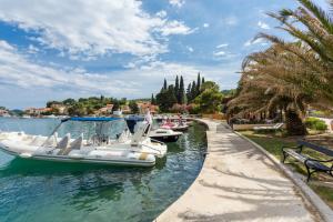 a row of boats docked in a canal with a bench at Villa Florence - Mediterranean GardenPool in Zaton