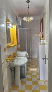 a white bathroom with a sink and a mirror at Dimora Maffi in Metaponto +31 photos