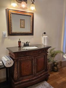 a bathroom with a wooden vanity with a sink at Langdon Hill House in Gettysburg +24 photos