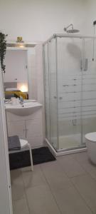 a bathroom with a glass shower and a sink at Cristel malpensa room in Cardano al Campo +13 photos