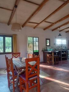 a dining room with a wooden table and chairs at Autóctona in Villa Cura Brochero