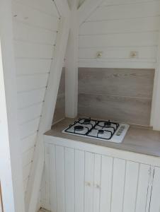 a kitchen with a stove top in a attic at Chez Patrick in Sainte-Rose +7 photos
