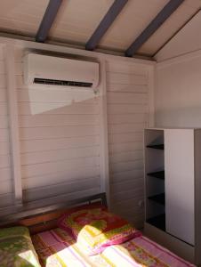 a small bedroom with a bed and a closet at Chez Patrick in Sainte-Rose
