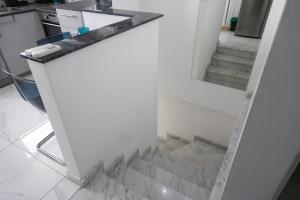 a staircase in a kitchen with a mirror at Nautica Luxe Beachfront in Oroklini +16 photos