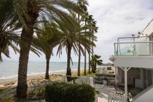 a view of the beach from the balcony of a house at Nautica Luxe Beachfront in Oroklini