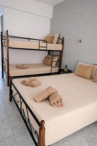 two bunk beds with towels on top of them in a room at Matinas rooms in Nea Mesangala +1 photo
