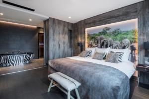 a bedroom with a large bed with a painting of elephants at Van der Valk Hotel Utrecht in Utrecht +75 photos