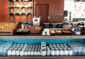 a counter with a bunch of food and drinks at B&B HOTEL Nyon in Nyon