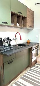 a kitchen with a sink and a stove at sunwave Tolo in Tolo +10 photos