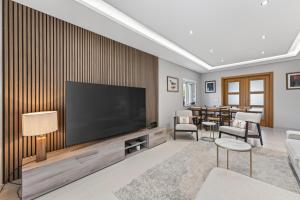 a living room with a large flat screen tv at Townhouse Sasha in Almancil