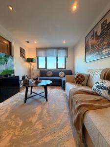 a living room with a couch and a table at VIP apartment paddington in London