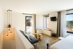 a bedroom with two beds and a large window at Viladraga - Casa da Ursa in Colares +37 photos