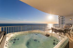 a hot tub on a balcony with the ocean at Turquoise 1908C in Orange Beach