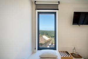 a room with a window with a view at Viladraga - Casa da Ursa in Colares