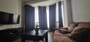 a living room with a couch and a coffee table at Cozy Corner in Tbilisi City