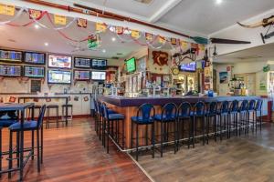 a restaurant with a bar and tables in it at Fernvale Hotel Motel in Fernvale