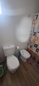 a bathroom with a white toilet and a bidet at La Raquel in La Plata
