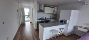 a kitchen with white cabinets and a counter top at La Raquel in La Plata
