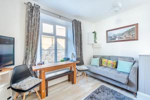 a living room with a desk and a couch at Wanderer's Rest in Lynton