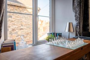 a table with glass chessetts on it in front of a window at Wanderer's Rest in Lynton