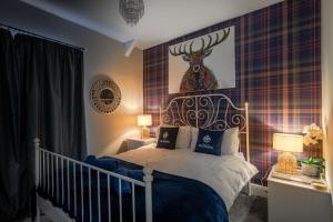 a bedroom with a bed with a deer head on the wall at Wanderer's Rest in Lynton