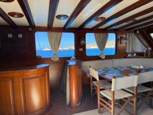 a dining room on a boat with a table and chairs at Caicco Silver Star 2 by Blue Marine in Lampedusa