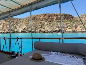 a hat sitting on a boat in the water at Caicco Silver Star 2 by Blue Marine in Lampedusa