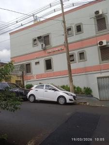 a white car parked in front of a building at HOTEL CENTER Ribeirão in Ribeirão Preto