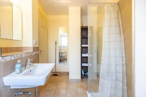 a bathroom with a sink and a shower at Dat lütte Huus - Wohnung 1 in Husum +12 photos