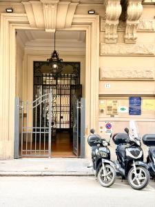 two scooters parked in front of a building at Hotel Duca D'Aosta in Florence