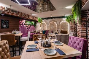 a restaurant with wooden tables and purple chairs at Villa Nautica Stone House in Split
