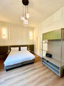 a bedroom with a large white bed and two lights at Hotel Duca D'Aosta in Florence